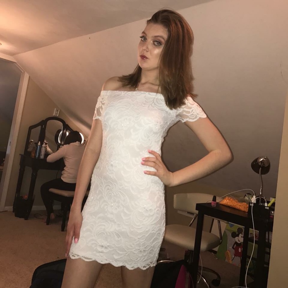 A white lace off the shoulder body-con dress.